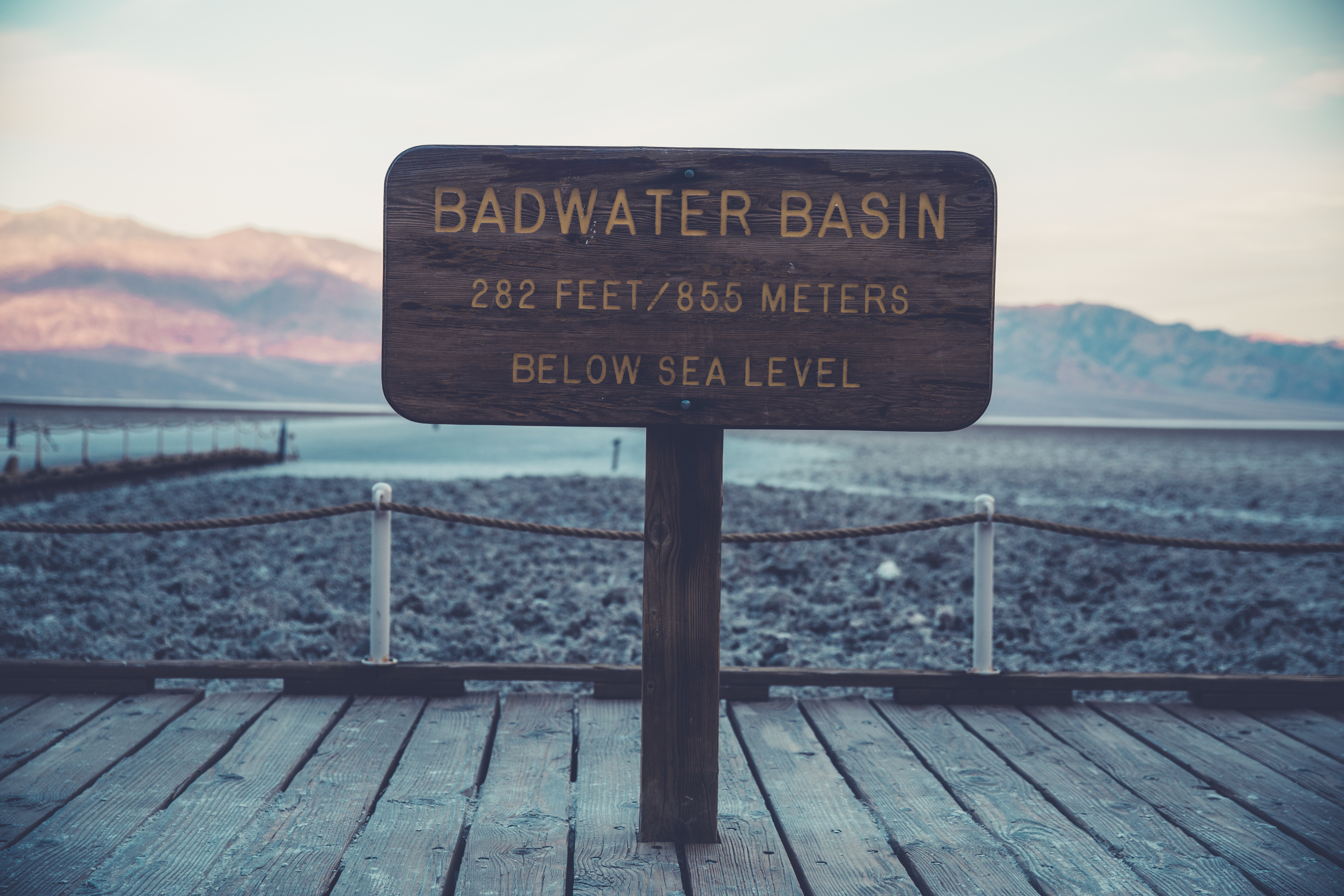 badwater basin signage on brown wooden hallway